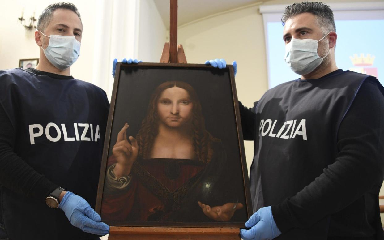 Italian police display the recovered painting, a copy of Leonardo's Salvator Mundi - Shutterstock