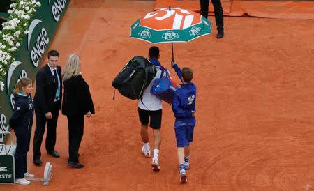 Tennis - French Open - Roland Garros - Novak Djokovic of Serbia v Roberto Bautista Agut of Spain - Paris, France - 31/05/16. Djokovic leaves the court as it rains. REUTERS/Gonzalo Fuentes