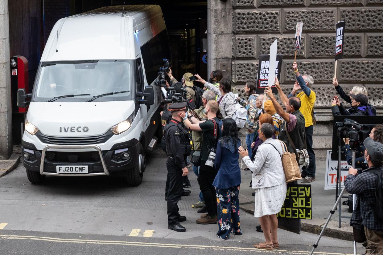 Supporters of Wikileaks founder Julian Assange and members of the media gather at the exit to the Old Bailey as a van believed to be carrying Assange leaves following his appearance at the resumption of his extradition trial hearing on Sept. 7, 2020, in London, England. Assange, who has been in Belmarsh Prison for 16 months, is wanted in the U.S. over the publication of classified documents in 2010 and 2011.