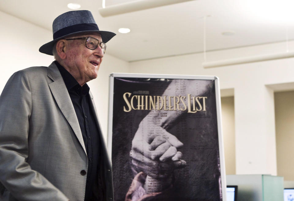 FILE - In this Wednesday, July 22, 2015 file photo, Branko Lustig stands next to a poster of the film Schindler's List at Yad Vashem Holocaust memorial in Jerusalem. Lustig, one of the producers of Schindler's List, presented his Academy Award to Yad Vashem Holocaust memorial on Wednesday, saying it had found its rightful resting place. Lustig, an Oscar-winning Croatian film producer and Holocaust survivor, has died at 87. The Yad Vashem center in Jerusalem said Lustig died Thursday, Nov. 14, 2019 in Zagreb, the capital of his native Croatia. Lustig is best known for winning Academy Awards for Best Picture for Steven Spielberg’s “Schindler's List” and for Ridley Scott’s “Gladiator.” (Nir Elias/Pool Photo via AP, file)