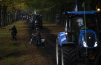 Protesting farmers arrive in The Hague, Netherlands, Wednesday, Oct. 16, 2019. Thousands of Dutch farmers protest over the Netherlands efforts to drastically reduce emissions of greenhouse gases. Among the farmers' demands are that the government does not further reduce the number of animals they can keep. (AP Photo/Peter Dejong)