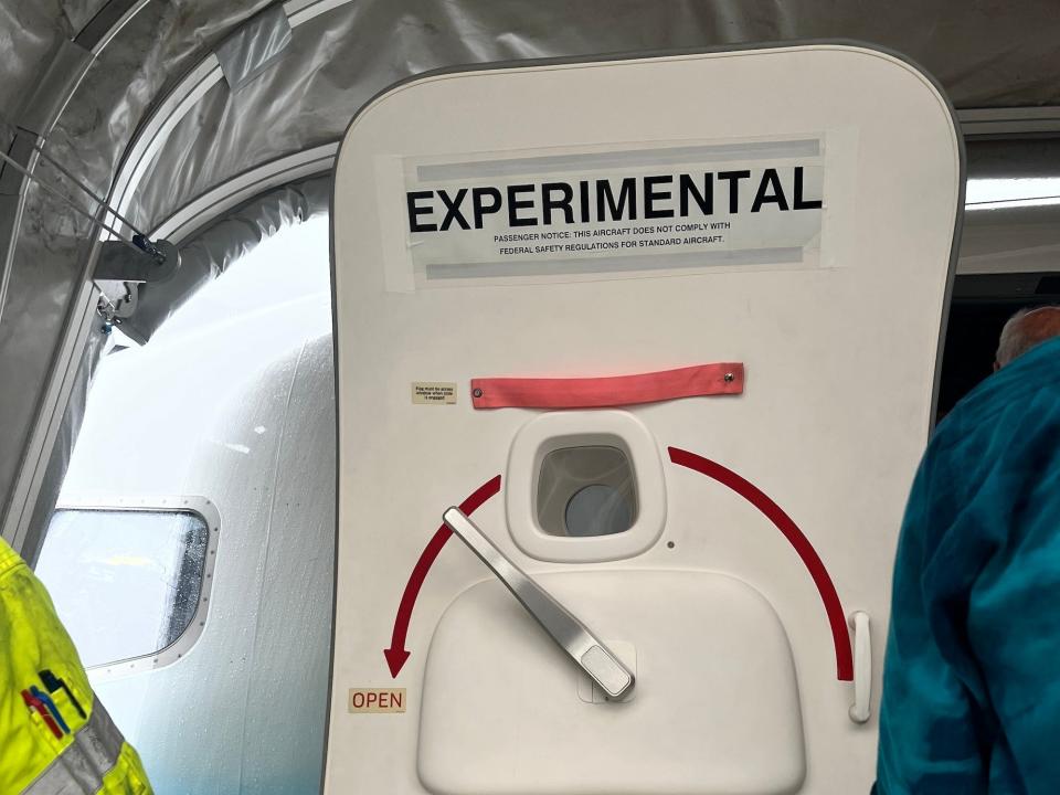 The boarding door with the sign "experimental" on it.