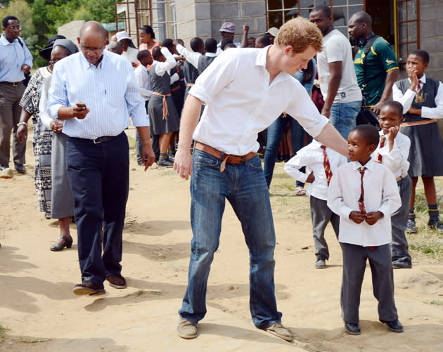 Prince Harry with a young boy from the Kananelo Centre. Prince Harry was last in Lesotho in June 2010 with Prince William (Tim Rooke/Rex Features)