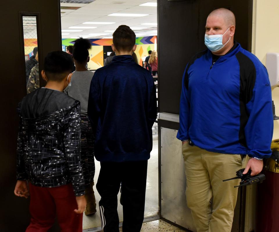Student Resource Officer Brian Winsjansen watches as students at Monroe Middle School head into the cafeteria for lunch. The officer has been at the school for the past six years.