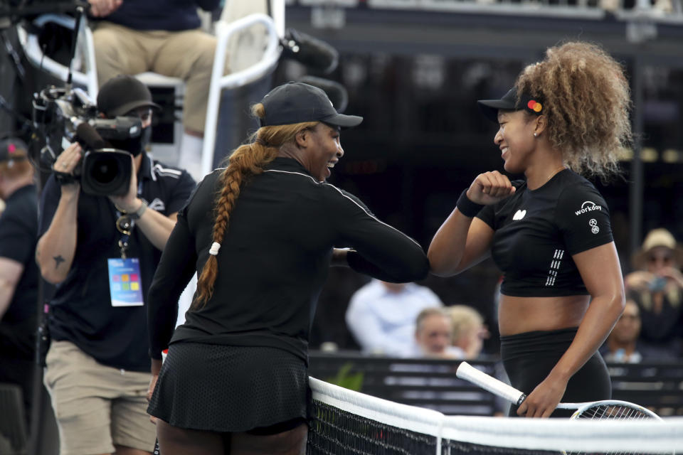 United States' Serena Williams, left, and Japan's Naomi Osaka gesture with their elbows following an exhibition tennis event in Adelaide, Australia, Friday, Jan 29. 2021. (Kelly Barnes/AAP Image via AP)
