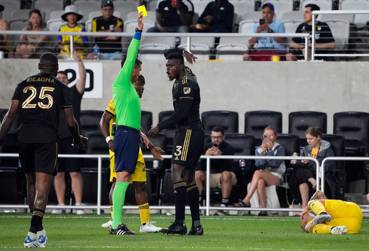 May 21, 2022; Columbus, Ohio, USA; Los Angeles FC defender Jesus David Murillo (3) receives a yellow card from referee Victor Rivas after fouling Columbus Crew midfielder Lucas Zelarayan (10) during the 2nd half of the MLS game between the Columbus Crew and Los Angeles FC at Lower.com Field in Columbus, Ohio on May 21, 2022.