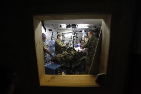 Medical staff of 125 BSB Forward Surgical Team Task Force Mustang treat a wounded Afghan civilian, injured by an IED (improvised explosive device) in Forward Operating Base (FOB) Shank, in Logar province, eastern Afghanistan in this November 10, 2011 file photo. REUTERS/Umit Bektas