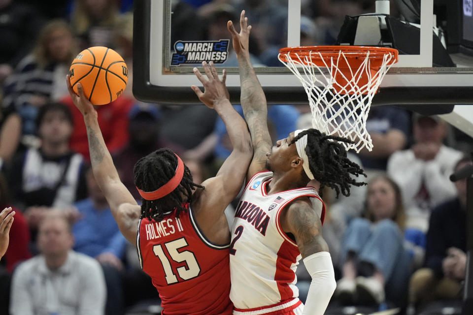 Arizona guard Caleb Love (2) defends as Dayton forward DaRon Holmes II (15) shoots during the second half of a second-round college basketball game in the NCAA Tournament in Salt Lake City, Saturday, March 23, 2024. (AP Photo/Rick Bowmer)