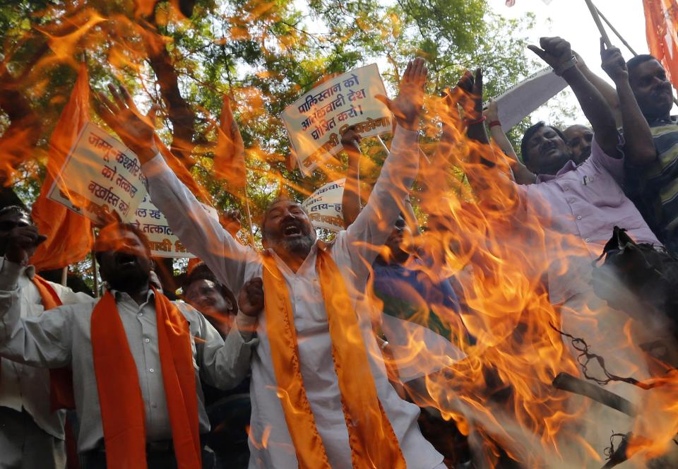 Supporters of Rashtrawadi Shiv Sena, a Hindu hardline group, shout slogans as they burn an effigy depicting Jammu and Kashmir chief minister Omar Abdullah during a protest against Thursday's militant attack in Jammu, in New Delhi September 27, 2013. Militants dressed in Indian army uniforms attacked Indian police and soldiers near the border with Pakistan on Thursday, killing nine people and triggering calls for talks between the prime ministers of the rival nations to be called off. The placards read: "Immediately dismiss government of Jammu and Kashmir" and "Declare Pakistan a terrorist state". (REUTERS/Adnan Abidi)