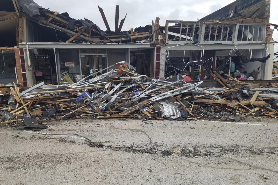 A row of buildings is left damaged by a tornado in Sulphur, Okla., Sunday, April 28, 2024. (AP Photo/Ken Miller)