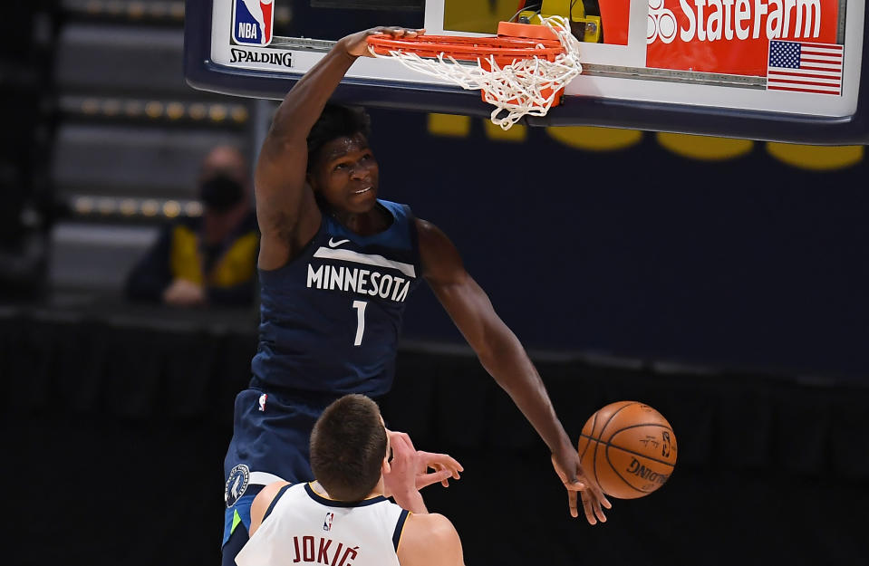 Jan 5, 2021; Denver, Colorado, USA;  Minnesota Timberwolves guard Anthony Edwards (1) dunks over Denver Nuggets center Nikola Jokic (15) in the second quarter at Ball Arena. Mandatory Credit: Ron Chenoy-USA TODAY Sports