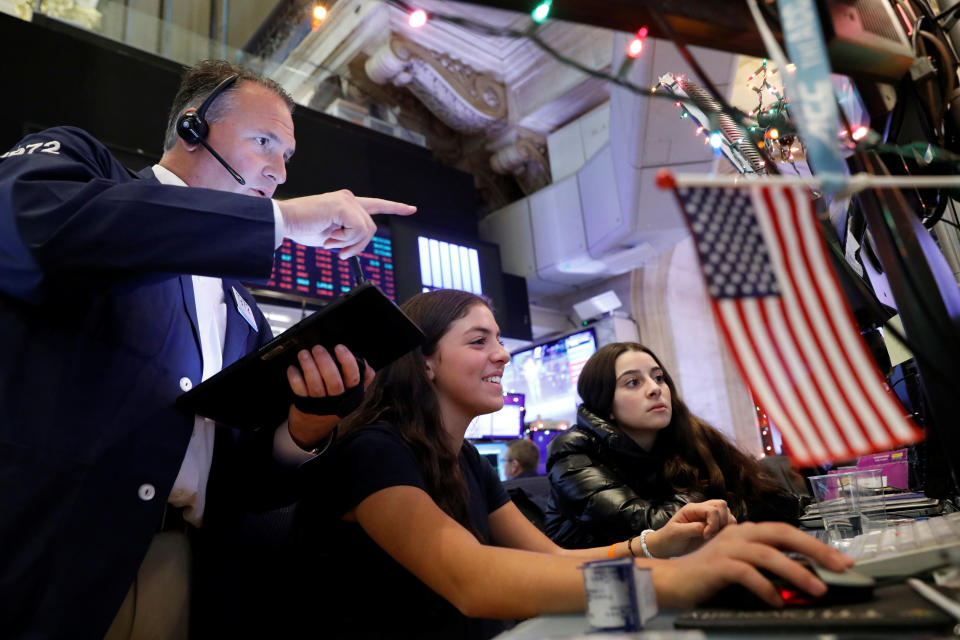 Trader Jonathan Corpina works with children during a traditional bring-your-kids-to-work day on the floor at the  New York Stock Exchange (NYSE) in New York, U.S., November 29, 2019. REUTERS/Brendan McDermid