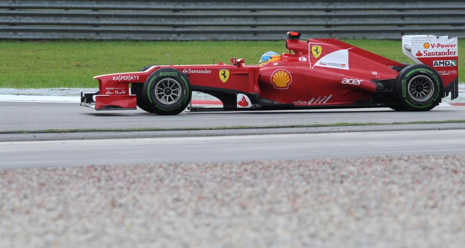 Ferrari driver Fernando Alonso of Spain speeds up during Formula One's Malaysian Grand Prix at the Sepang International Circuit in Sepang on March 25, 2012.    AFP PHOTO / ROSLAN RAHMAN (Photo credit should read ROSLAN RAHMAN/AFP/Getty Images)