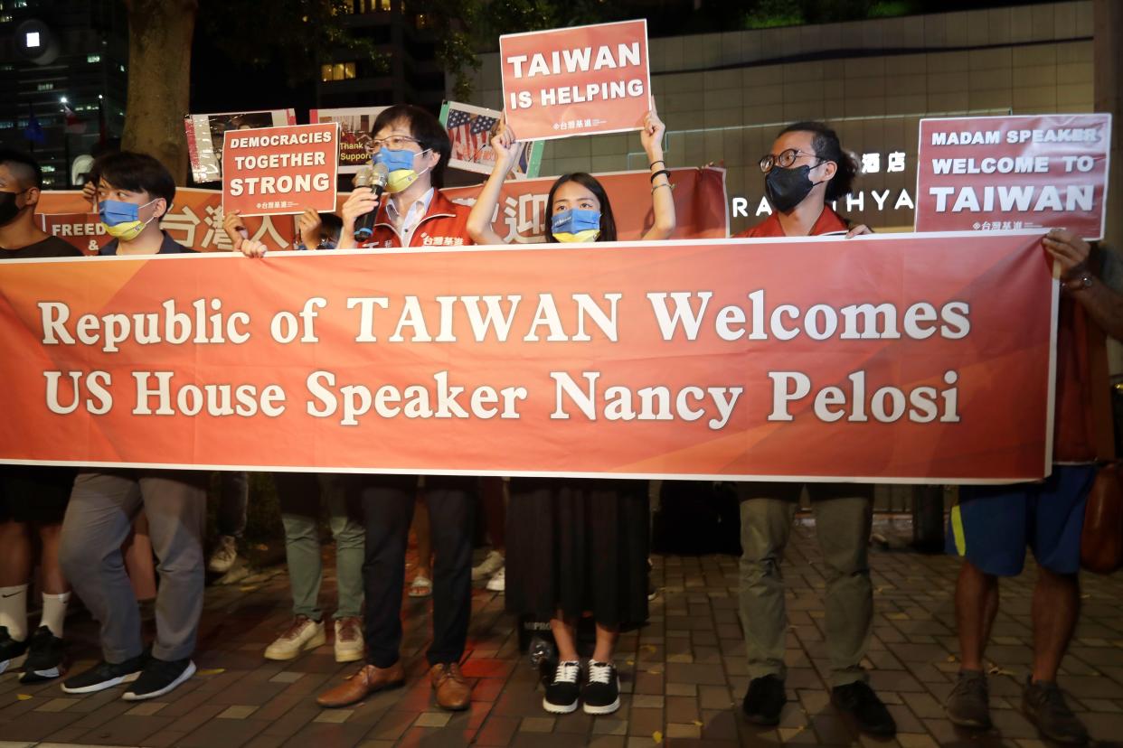 Supporters hold a banner outside the hotel where House Speaker Nancy Pelosi is supposed to be staying in Taipei, Taiwan, Tuesday, Aug 2, 2022.