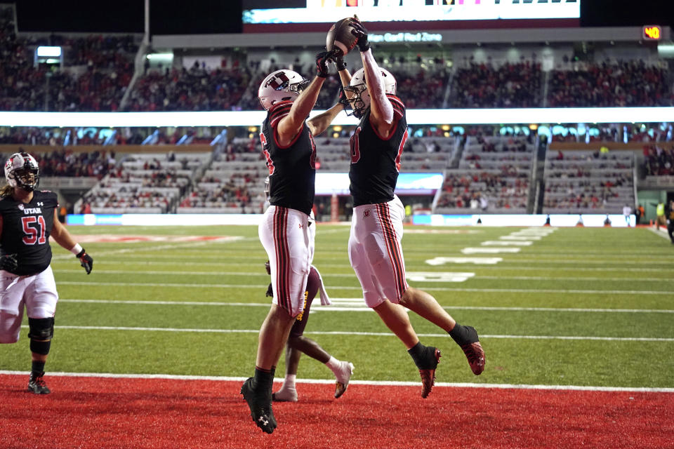 Utah tight end Brant Kuithe, right, celebrates after scoring against Arizona State with teammate Dalton Kincaid in the second half during an NCAA college football game Saturday, Oct. 16, 2021, in Salt Lake City. (AP Photo/Rick Bowmer)