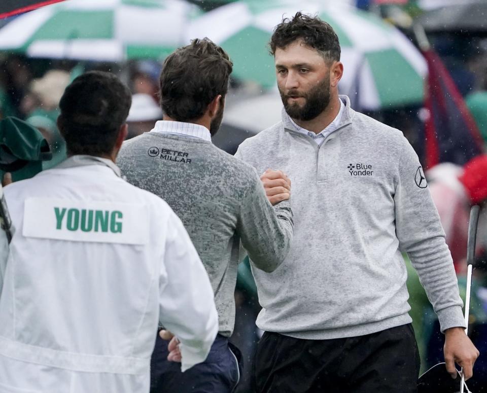 Jon Rahm (right) shakes hands with Cameron Young after the two players finished Round 2 on Saturday morning.