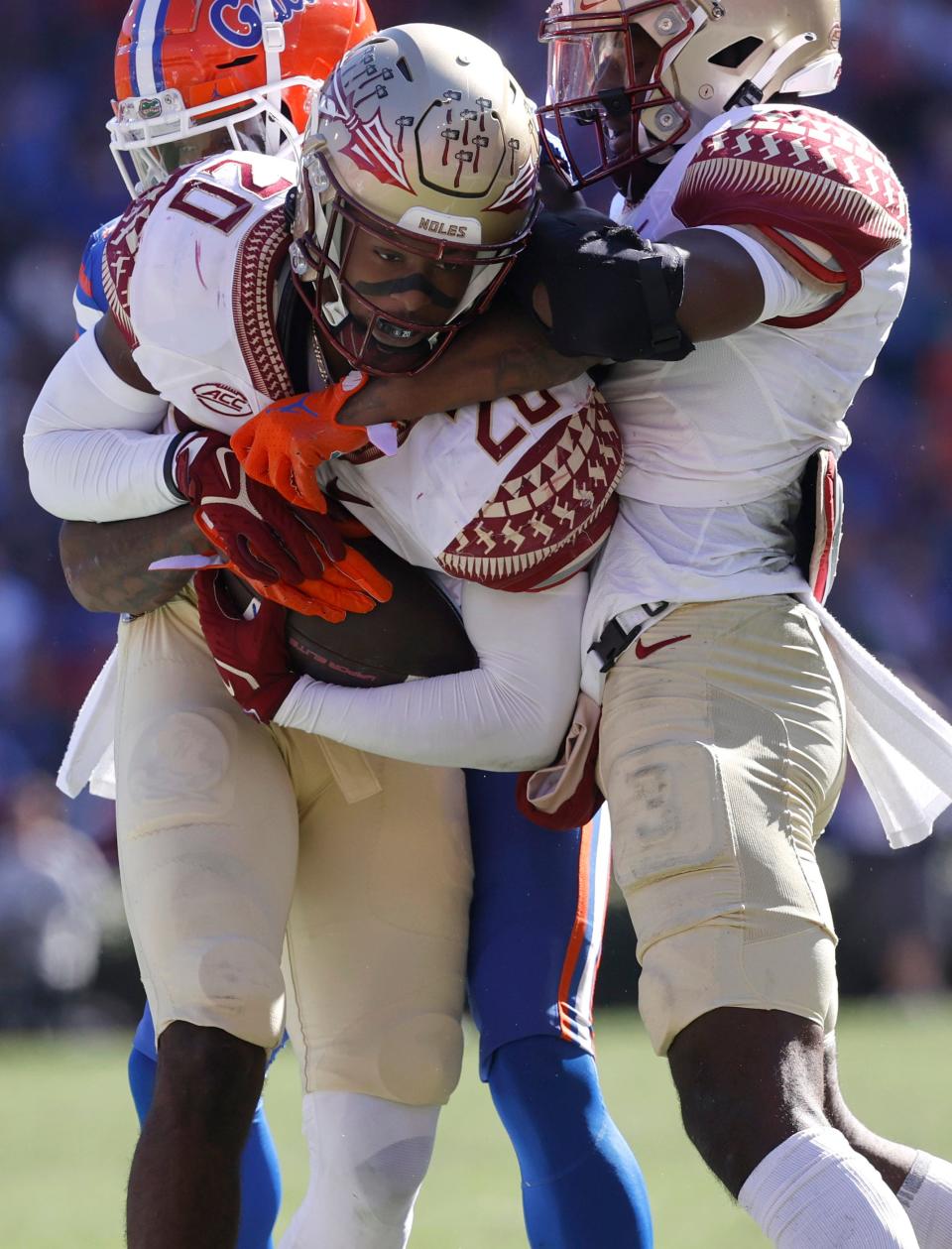 Florida State Seminoles linebacker Kalen DeLoach (20) intercepts the ball over Florida Gators wide receiver Jacob Copeland (1) during the second quarter at Ben Hill Griffin Stadium.