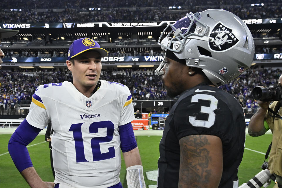 Minnesota Vikings quarterback Nick Mullens (12) talks with Las Vegas Raiders wide receiver DeAndre Carter (3) after an NFL football game, Sunday, Dec. 10, 2023, in Las Vegas. (AP Photo/David Becker)