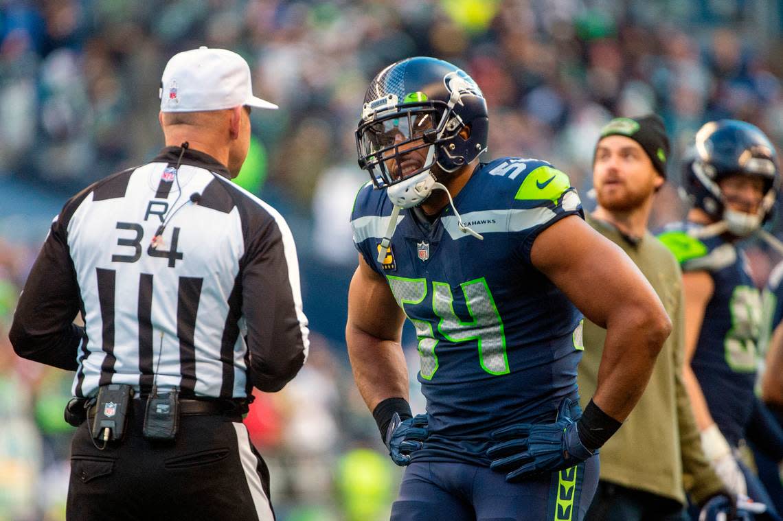 Seattle Seahawks middle linebacker Bobby Wagner (54) talks to an official during a timeout for an official review of and interception by Seattle Seahawks cornerback Sidney Jones (23) during the third quarter of an NFL game on Sunday afternoon at Lumen Field in Seattle.The referee crew was reviewing the interception and return by Seattle Seahawks cornerback Sidney Jones (23). The interception was overruled by the officials and Arizona was retained possession of the ball. Pete Caster/pcaster@thenewstribune.com