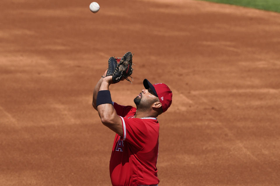 Los Angeles Angels' Albert Pujols catches a fly out hit by Cleveland Indians' Yu Chang during the first inning of a spring training baseball game, Tuesday, March 16, 2021, in Tempe, Ariz. (AP Photo/Matt York)