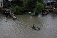 A man rows a makeshift boat to reach his house isolated by sea water at Pantai Mekar village in Bekasi, West Java province, Indonesia, January 22, 2018. REUTERS/Beawiharta