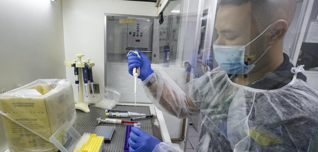 A virology lab researcher works to develop a test that will detect the P.1 variant of the coronavirus, in São Paulo, Brazil, in March 2021. (AP Photo/Andre Penner)