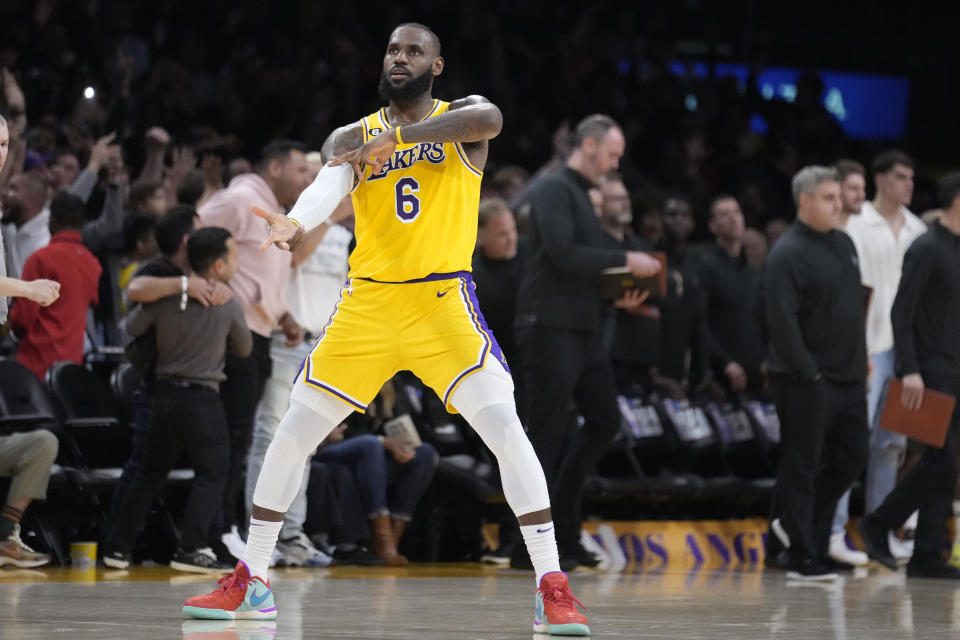 Los Angeles Lakers forward LeBron James (6) celebrates after a 3-point basket by Dennis Schroder in the closing second of regulation in the team's NBA basketball play-in tournament game against the Minnesota Timberwolves on Tuesday, April 11, 2023, in Los Angeles. (AP Photo/Marcio Jose Sanchez)