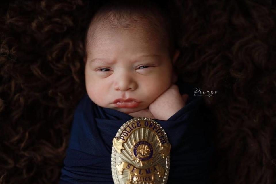 Nearly two months after Selma Police officer Gonzalo Carrasco Jr. died in the line of duty, his son took newborn photos while swaddled in a navy blue blanket and with the officer’s badge. Courtesy photo/Picazo Photography