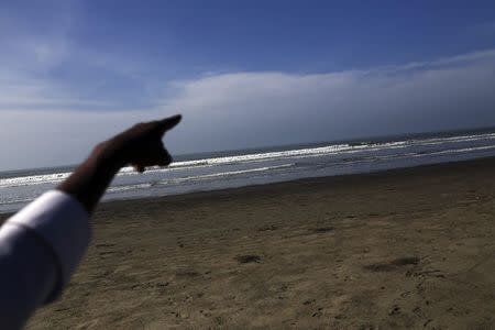 A Rohingya, who requested for anonymity because he is afraid of the authorities, points at the sea exit where Rohingya boats allegedly illegally leave from, in Byuhar Kone village, Maungdaw town in northern Rakhine State November 10, 2014. REUTERS/Minzayar