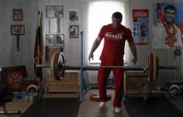 Olympic silver medallist weightlifter Dmitry Klokov drops weights during training at his father's house in the village of Sinkovo outside Moscow, April 3, 2012.