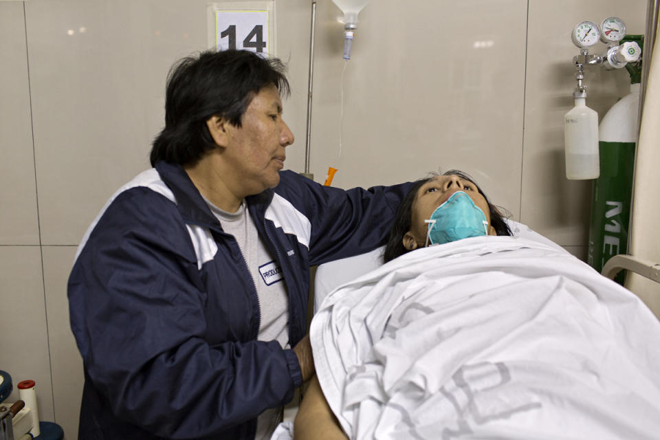 <p>Evila comforts Tamara in the hospital where she gets support treatment for her worsening complications with tuberculosis and HIV. Tamara died on Jan. 11, 2017, less than a month after her 30th birthday. (Photo: Danielle Villasana) </p>