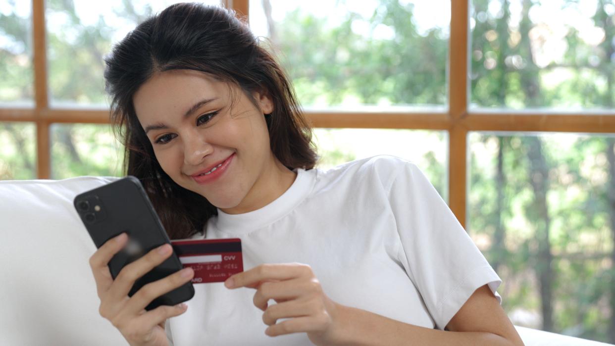 Woman shopping or pay online on internet marketplace browsing for sale items for modern lifestyle and use credit card for online payment from wallet
