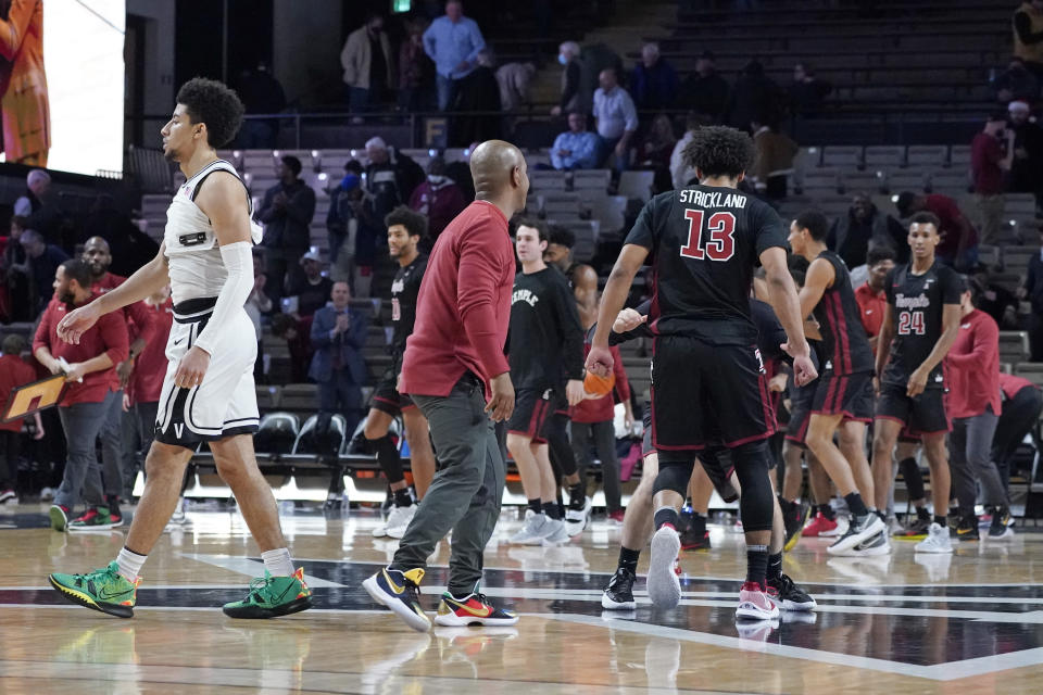 Vanderbilt's Scotty Pippen Jr., left, walks off the court as Temple's Tai Strickland (13) and teammates celebrate their 72-68 win in overtime in an NCAA college basketball game Tuesday, Dec. 7, 2021, in Nashville, Tenn. (AP Photo/Mark Humphrey)