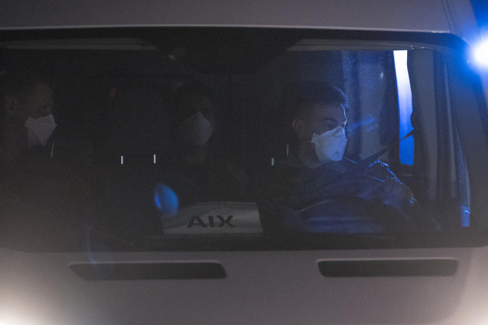 A van of support staff arrive as French citizens returning from the virus-hit city of Wuhan arrive in Aix-en-Provence, southern France, Sunday, Feb. 2, 2020. A second French-chartered plane carrying 300 evacuees from China flew to France on Sunday as more foreigners fled China's rapidly developing virus. (AP Photo/Daniel Cole)