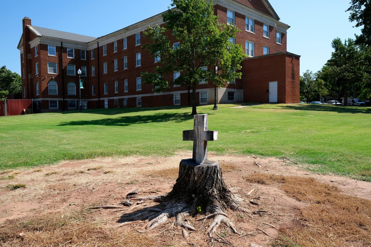 A cross was cut into a tree stump by Oklahoma Baptist Disaster Relief teams that helped with tornado repairs and recovery at Oklahoma Baptist University in Shawnee.