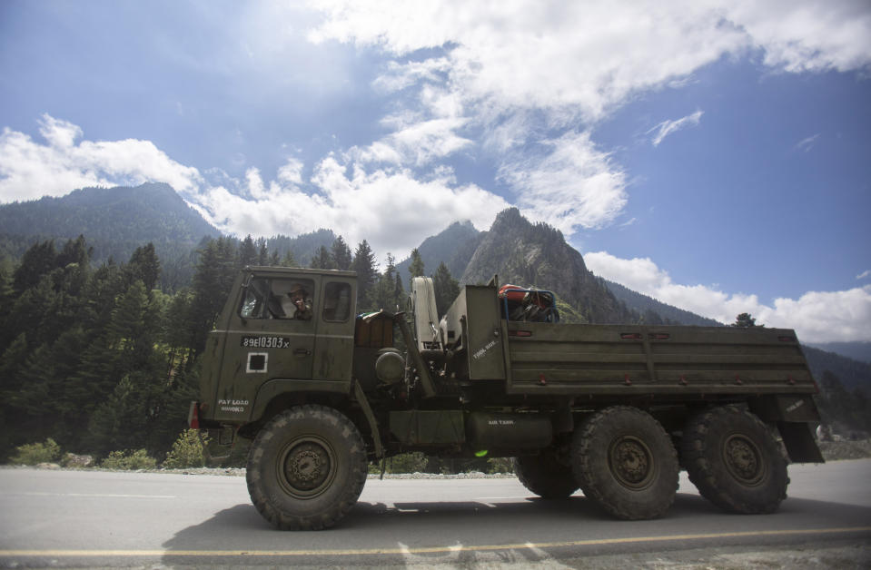 An Indian army soldier gestures towards the photographer as his convoy moves on the Srinagar- Ladakh highway at Gagangeer, northeast of Srinagar, Indian-controlled Kashmir, Tuesday, Sept. 1, 2020. India said Monday its soldiers thwarted “provocative” movements by China’s military near a disputed border in the Ladakh region months into the rival nations’ deadliest standoff in decades. China's military said it was taking “necessary actions in response," without giving details. (AP Photo/Mukhtar Khan)