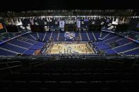 Greensboro Coliseum is mostly empty after the NCAA college basketball games were cancelled at the Atlantic Coast Conference tournament in Greensboro, N.C., Thursday, March 12, 2020. The biggest conferences in college sports all canceled their basketball tournaments because of the new coronavirus, seemingly putting the NCAA Tournament in doubt. (AP Photo/Gerry Broome)