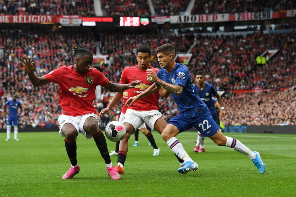 MANCHESTER, ENGLAND - AUGUST 11: Christian Pulisic of Chelsea battles for possession with Manchester United players Aaron Wan-Bissaka and Jesse Lingard during the Premier League match between Manchester United and Chelsea FC at Old Trafford on August 11, 2019 in Manchester, United Kingdom. (Photo by Clive Howes - Chelsea FC/Chelsea FC via Getty Images)