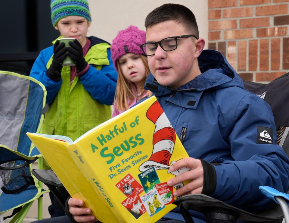 Jan. 16, 2023; Columbus, Ohio, USA; Thomas Bornman, a 14-year-old Olentangy Hyatts Middle School student, reads The Sneetches by Dr. Seuss during a peaceful demonstration at the Olentangy Schools Administration Building on Monday, Martin Luther King Day. Recently a Olentangy Schools teacher who was reading a Dr. Seuss book on an NPR podcast was stopped by an administrator after questions about race came up. Mandatory Credit: Barbara J. Perenic/Columbus Dispatch