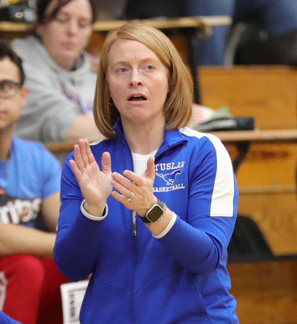 Tuslaw girls basketball coach Kathryn Rowbotham claps in front of the bench Wednesday.