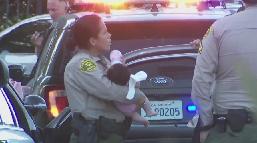 A Los Angeles County sheriff's deputy seen caring for a 2-month-old girl after a dangerous high-speed pursuit on July 17, 2024. (KTLA)