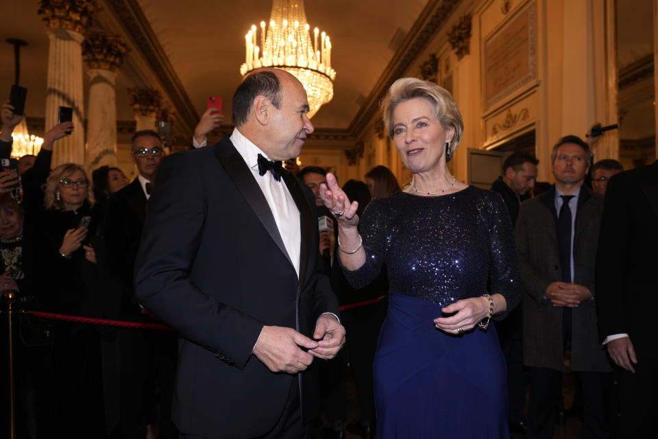 European Commission President Ursula von der Leyen, right, is received by La Scala Superintendent Dominique Meyer as she arrives for the premiere of Modest Mussorgsky's Boris Godunov in Milan, Italy, Wednesday, Dec. 7, 2022. Italy’s most famous opera house, Teatro alla Scala, opened its new season Wednesday with the Russian opera “Boris Godunov,” against the backdrop of Ukrainian protests that the cultural event is a propaganda win for the Kremlin during Russia’s invasion of Ukraine. (AP Photo/Antonio Calanni)