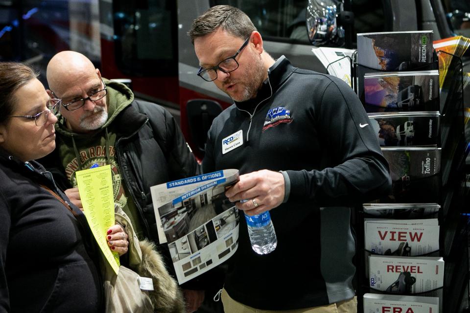 Shawn Coon of RCD RV helps potential buyers view different floor plans on Saturday during the 42nd Ohio RV & Boat Show at the Ohio Expo Celeste Center.