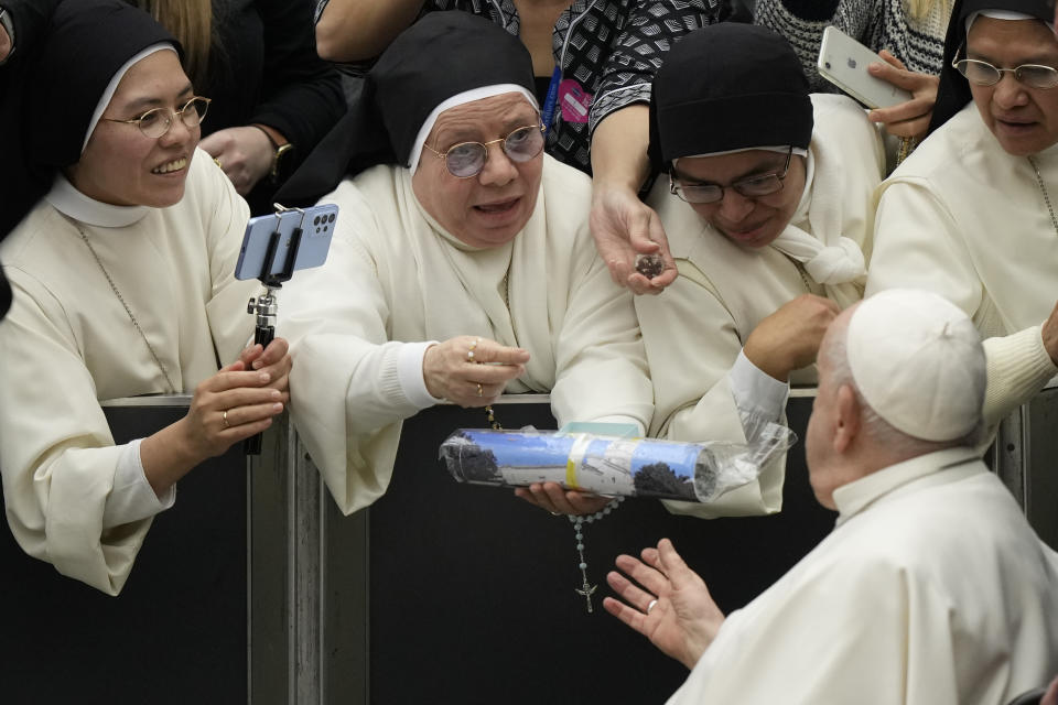 Pope Francis greets nuns during his weekly general audience in the Pope Paul VI hall at the Vatican, Wednesday, Dec. 20, 2023. (AP Photo/Andrew Medichini)