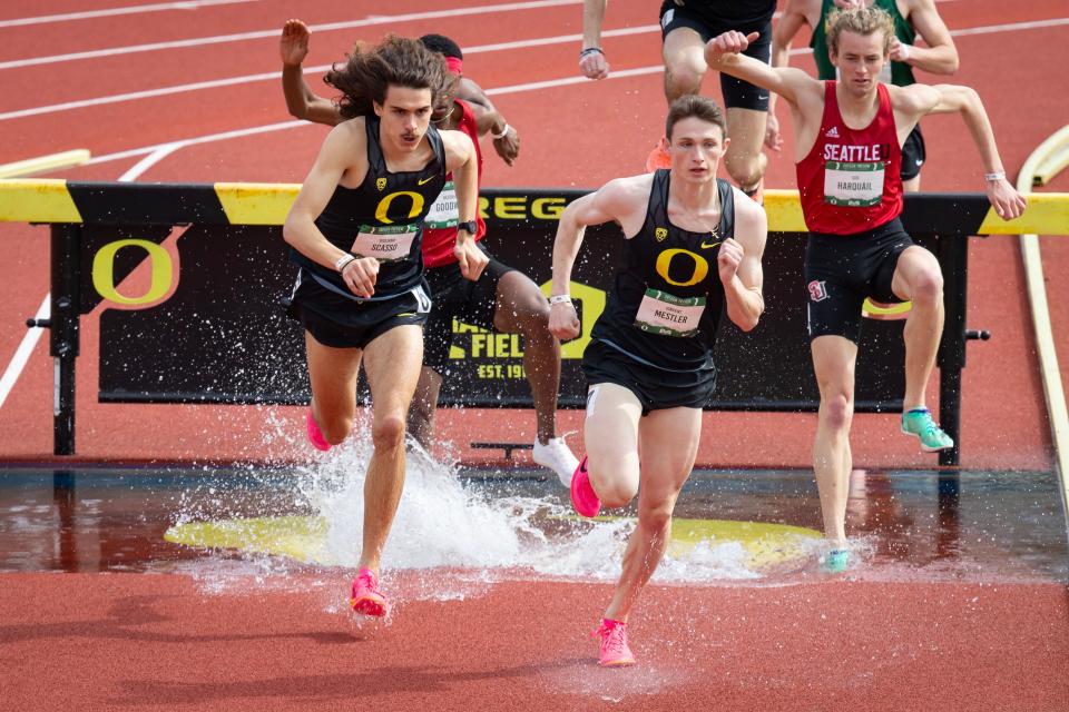 Oregon’s Vincent Mestler, center, and Giuliano Scasso sprint out of the water jump during the men’s 2,000 meter steeplechase during the Oregon Preview meet at Hayward Field in Eugene, Ore. Saturday, March 18, 2023.