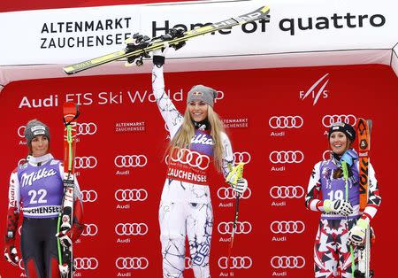 Lindsey Vonn (C) of the U.S. celebrates her victory next to second-placed Larisa Yurkiw (L) of Canada and third-placed Cornelia Huetter of Austria the Women's Sprint Downhill race of the Alpine Skiing World Cup in Zauchensee, Austria, January 9, 2016. REUTERS/Leonhard Foeger