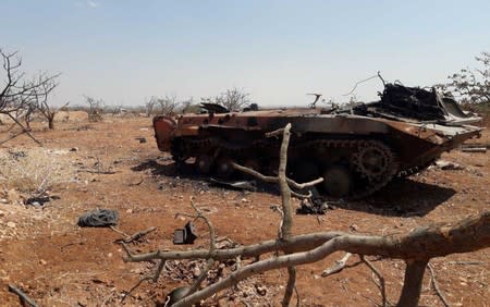 A damaged military tank is seen in Idlib countryside