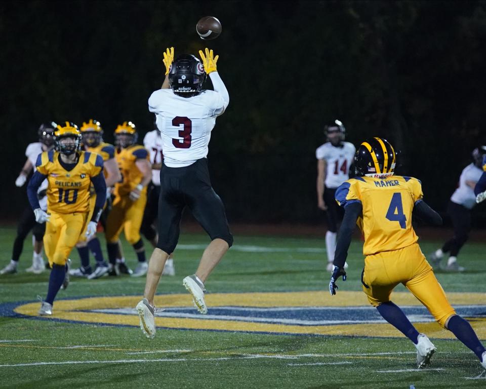 Rye's Rafferty McSweeney (3) pulls in a pass during their 20-6 win over Pelham in the Class A quarterfinal football game at Glover Field in Pelham on Friday, October 28, 2022.