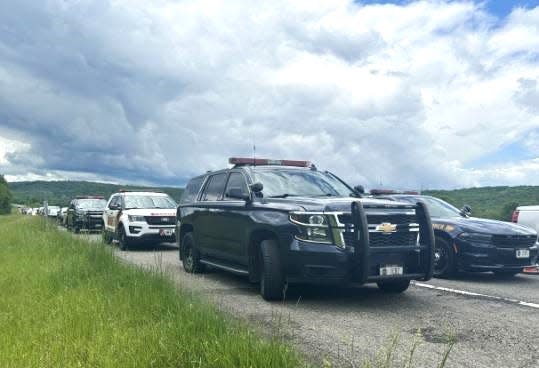 Law enforcement vehicles line the shoulder of Interstate 81 in northern Broome County on Wednesday May 29, 2024 for a memorial service to mark the 10th anniversary of the death of state Trooper Christopher Skinner, who was struck and killed while making a traffic stop.