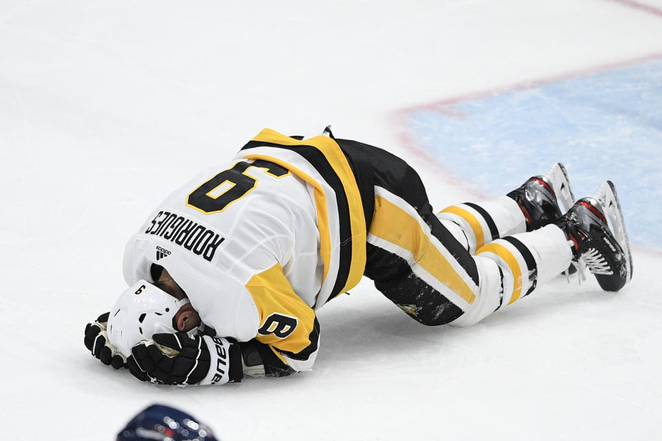 Pittsburgh Penguins center Evan Rodrigues reacts after he was injured during the first period of an NHL hockey game against the Washington Capitals, Thursday, April 29, 2021, in Washington. (AP Photo/Nick Wass)